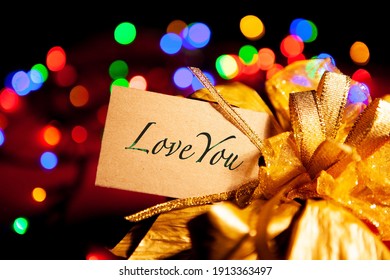 Love You - Text On A Gift Box Label With A Large Gold Bow. 