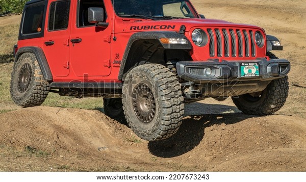 Loveland, CO, USA -\
August 27, 2022: Jeep Wrangler, Rubicon model,  on a dusty training\
drive off-road\
course.