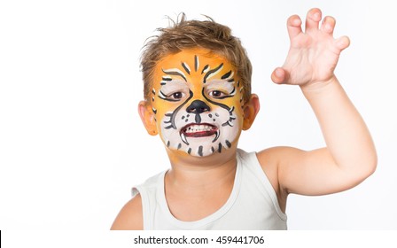lovely adorable kid with paintings on his face as a tiger or lion