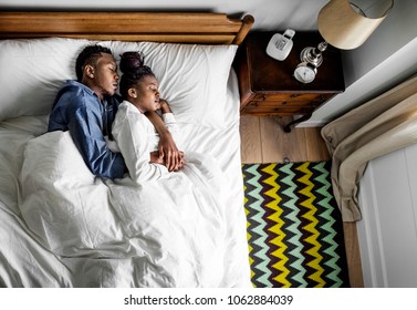 Lovely African American Couple Snuggling In Bed