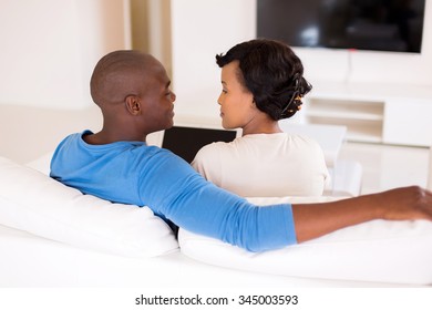 Lovely African American Couple Using Laptop In Living Room