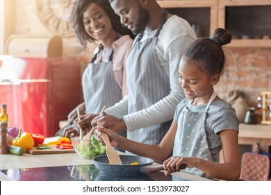 Lovely African Vegan Family Making Healthy Dinner Together, Daughter Learning Cooking, Parents Making Salad, Copy Space