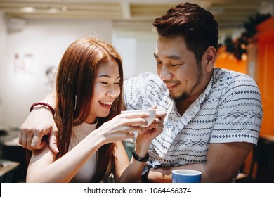 Lovely Asian Couple Having Coffee