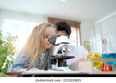 Lovely Asian Girl In Lab Coat Enjoy Doing An Experiment And Studying A Science. Smart Asian Little Boy Learning A Science Experimental With Expertise Scientist Or Science Researcher In Laboratory.