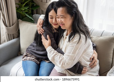 Lovely Asian Senior Mother And Young Daughter Hugging, Embracing, Loving Each Other Together With Happy Family Life, Single Mom, Togetherness Concept