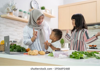 Lovely Asian Woman With Daughter And Son Cooking Dinner During Ramadan For Iftar Breaking The Fast