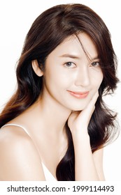 Lovely Asian Woman Are Happy With Perfect Clean Healthy Skin And Beautiful Long Dark Brown Hair. Cute Female Model Look At Camera. Expressive Facial Expressions. Chraming Woman Face Close Up Studio.