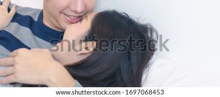 Lovely attractive young Asian smile couple man and woman with happy hug or embrace in romantic moment. Warm heart marriage and lover bonding and relationship. Husband and wife in love photo concept.
