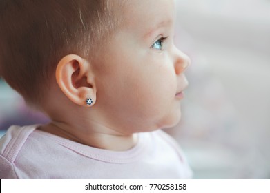 lovely baby face pierced ears star flower earrings blue eyes - Shutterstock ID 770258158