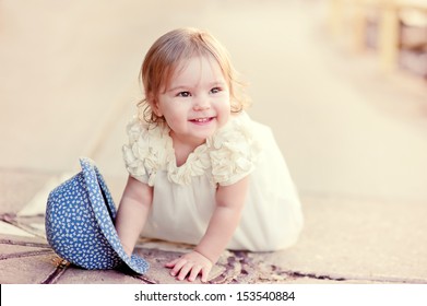 Lovely baby girl happy smiling in fashion dress outdoor
