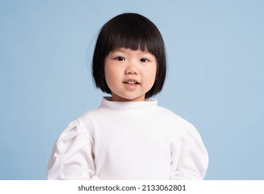lovely baby girl portrait, isolated on blue background