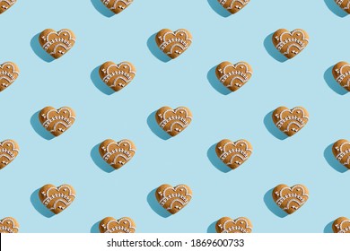 Lovely Bakery Pattern. Festive Pastry Cookies. Holiday Design. Homemade Decorated White Icing Ornament Gingerbread Hearts Isolated On Blue Pastel.