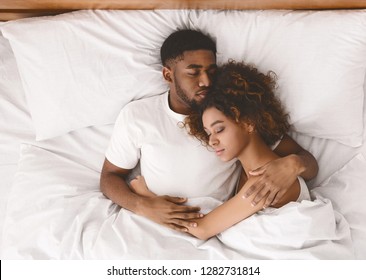 Lovely Black Couple Lying In White Bed, Sleeping Together, Top View