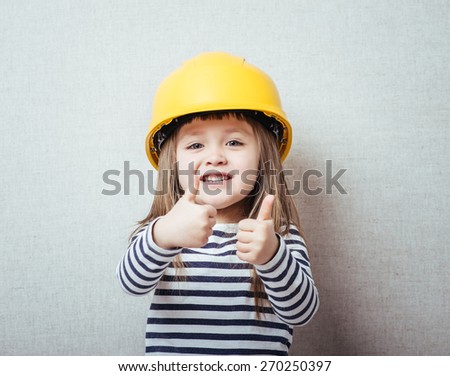 lovely blond little girl with yellow helmet 