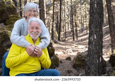 Lovely bonding happy senior couple embracing enjoying mountain hike in the forest expressing joy and freedom, retired seniors man and woman and healthy retirement lifestyle concept - Powered by Shutterstock