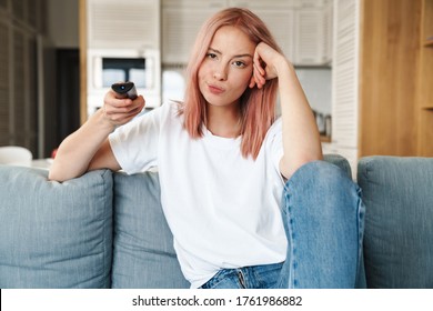 Lovely Bored Young Attractive Woman Relaxing On A Couch In The Living Room