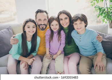 Lovely Charming Full Big Family Sit Couch Enjoy Spending Free Time Holidays Together Dad Daddy Mom Mommy Hug Her Preteen Schoolboy Small Girl In House Living Room