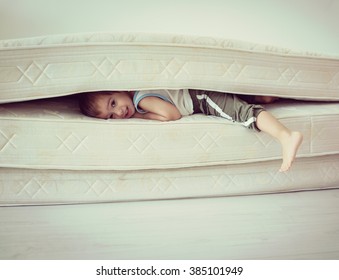 Lovely Child Laying Down On The Bed