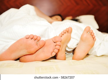 Lovely Couple In Bed, Focus On Feet