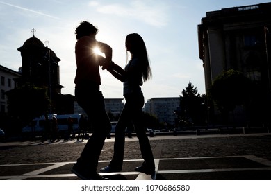 Lovely couple dancing West Coast Swing in the streets, carefree and happy.