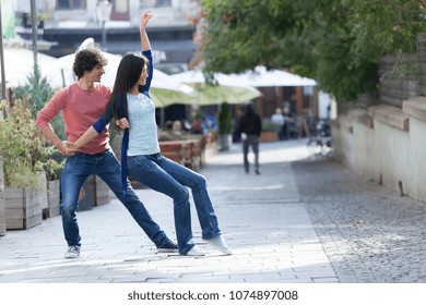 Lovely couple dancing West Coast Swing in the streets, carefree and happy.