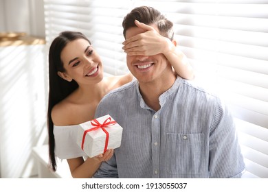 Lovely couple with gift box at home. Valentine's day celebration - Powered by Shutterstock