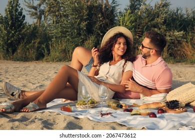 Lovely couple having picnic outdoors on sunny day - Powered by Shutterstock