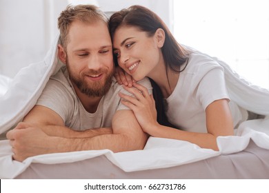 Lovely Couple Having Pillow Talk Underneath Blanket