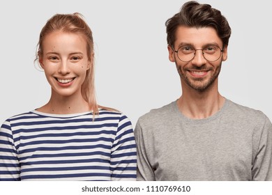 Lovely Couple In Love Pose For Making Photo In Family Album, Have Charming Smiles On Faces, Dressed In Casual Clothes. Happy European Woman With Pony Tail Rejoices Making Friends With Handsome Guy