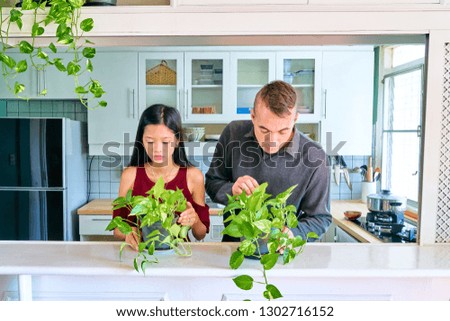 Lovely couple posing - taking care the plants