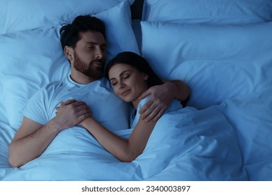 Lovely couple sleeping together in bed at night, top view - Powered by Shutterstock