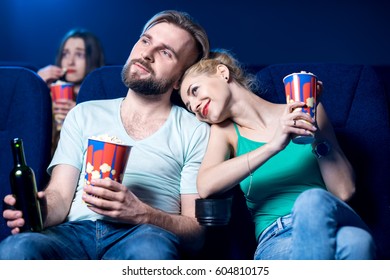 Lovely Couple Watching Film Sitting Together With Popcorn In The Cinema