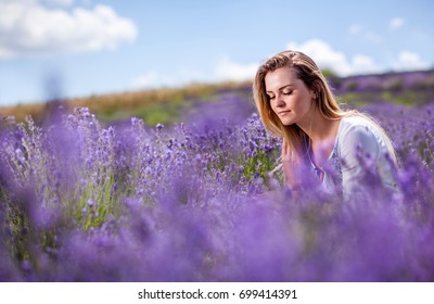 Lovely cute woman in lavender field at sunny day, freedom concept
