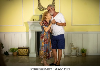 Lovely Elderly Couple Enjoys Romantic Dance To Celebrate Anniversary At Home. Senior Couple Doing Exercise By Dancing For Health. Elderly Wife And Husband Share Happy Time Together With Dance. 