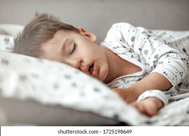 Lovely Face Expression With Open Mouth Of Blonde Caucasian Three Years Old Child, Sleeping On King Bed. Sweet Dreams. Little Baby Boy Sleeping While Lying On Couch At Home