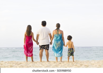 Lovely Family Enjoying At The Beach In Summer