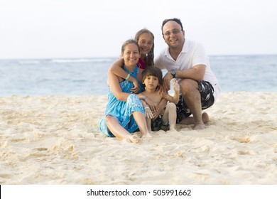 Lovely Family Enjoying At The Beach In Summer