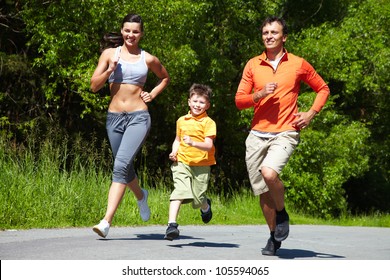 Lovely Family Jogging In The Open Air