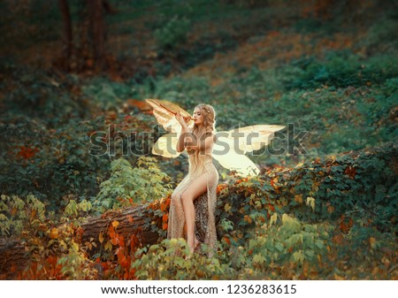 lovely girl druid with blond long hair, sits on a fallen tree, dressed in a gorgeous beige dress with open slim legs, transforming into a light forest butterfly, flashing on a wooden pipe alone.