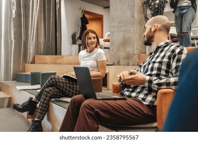Lovely girl listening to her hairless male colleague sharing a beautiful story. Hairless male explaining how he is feeling to his gorgeous female colleague - Shutterstock ID 2358795567