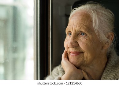 Lovely grandmother looking in a window, in a train