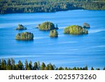 Lovely group of small islands in lake, Kuopio, Finland. Picture was taken at night during midsummer with longest day and midnight sun. 