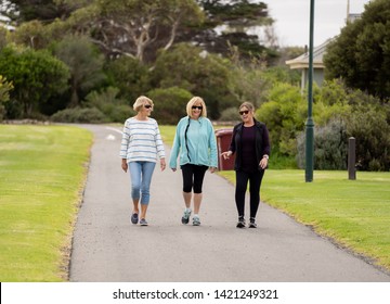 Lovely Group Of Three Senior Mature Retired Women On Their 60s Walking In Sportswear Doing Daily Exercise Routine Together In People Female Friendship And Active Retirement Healthy Lifestyle Concept.