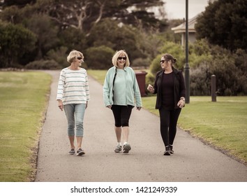 Lovely Group Of Three Senior Mature Retired Women On Their 60s Walking In Sportswear Doing Daily Exercise Routine Together In People Female Friendship And Active Retirement Healthy Lifestyle Concept.