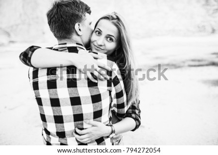 Lovely happy couple. Romantic black and white photo. Hugs together and have fun