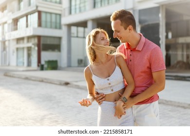 Lovely happy couple.Hugs together and smile in sunset light - Shutterstock ID 2215858171