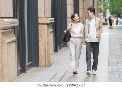 A Lovely Japanese Couple Walking In The City