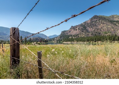 Lovely Landscape In Montana With A Summer Meadow Behind A Fence