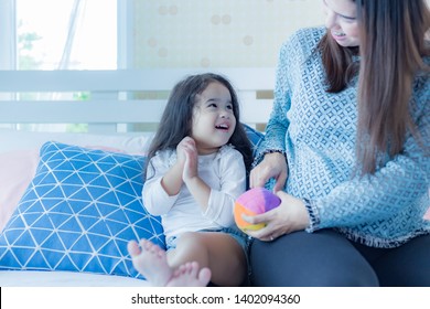 Lovely little asian girl or daughter looks at mom with love. Preschool child loves staying with mother that make her happiness and relaxing. Cute little angel stay and play together with her mother