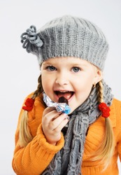 Lovely Little Girl Eating Chocolate Candy